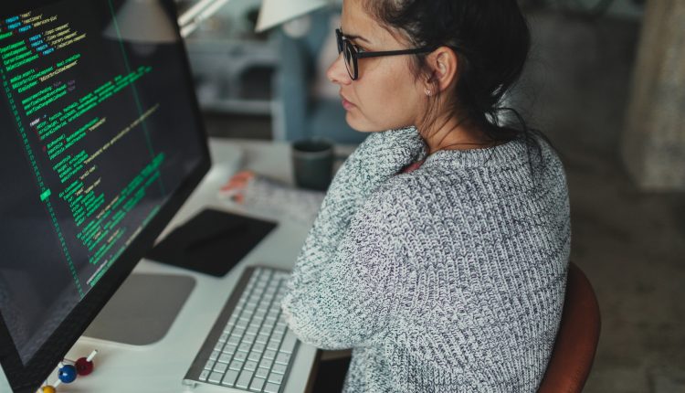 Young woman programming at her home office